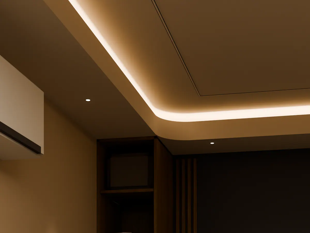 Looking up at a lit ceiling cove and recessed spots in a concept office.